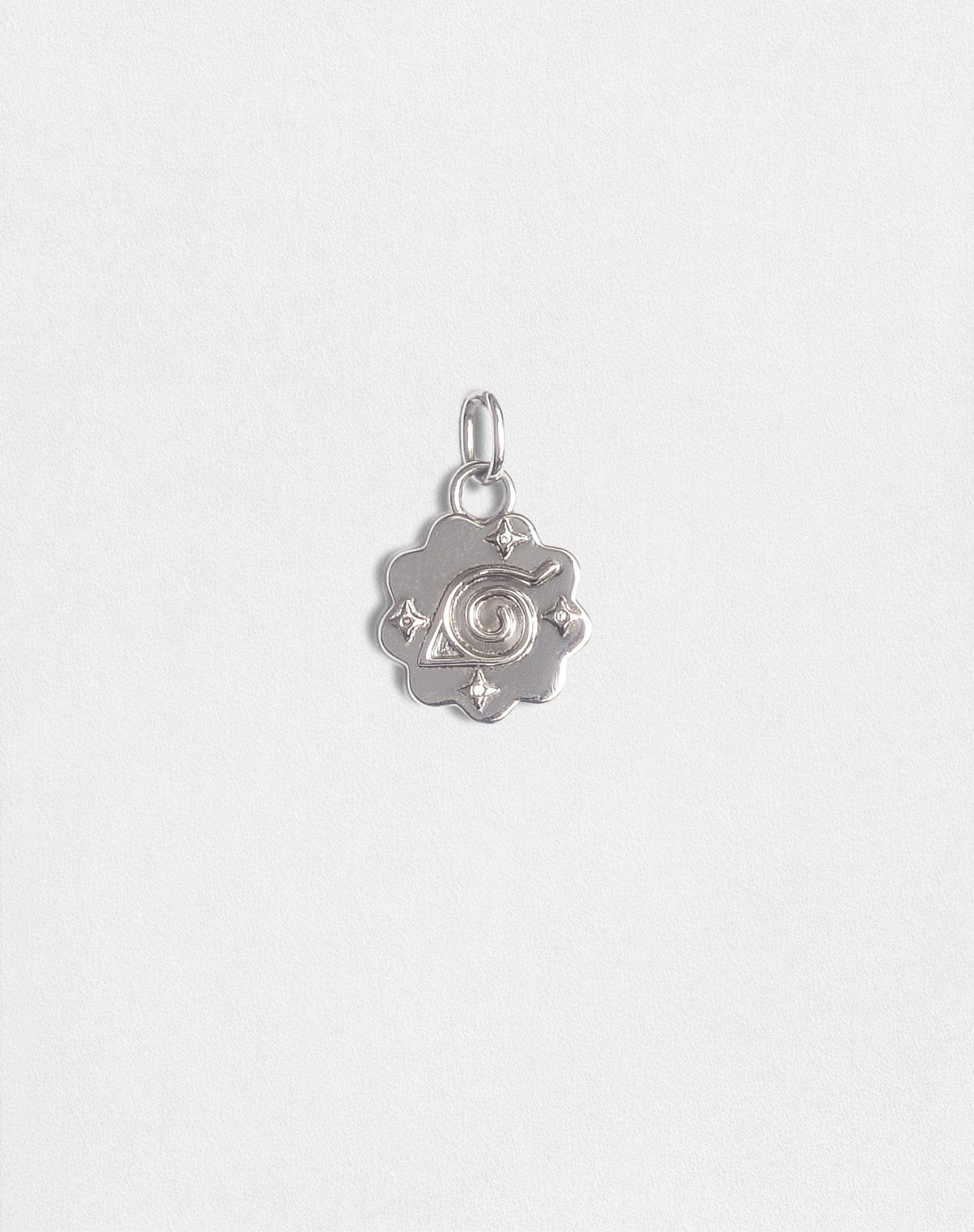 925 sterling silver Konoha charm with a polished finish and a narutomaki-inspired swirl design, designed by BOY OZU Toronto.