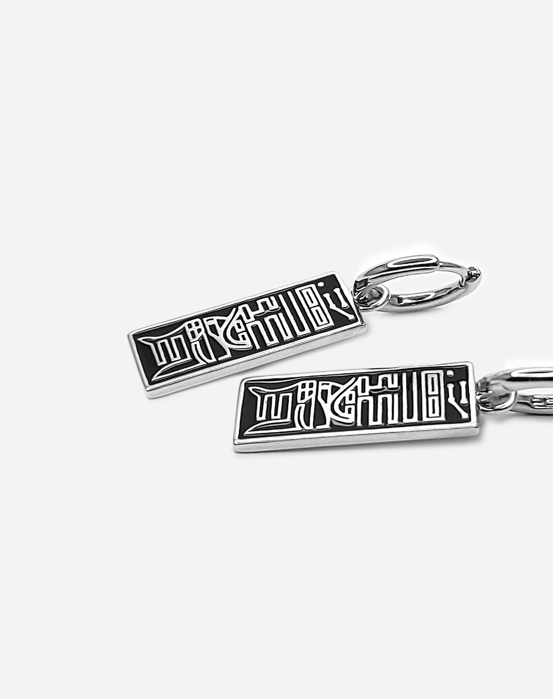 Alternative side view of the Curse Seal Earrings inspired by Jujutsu Kaisen aesthetics, highlighting the polished 925 sterling silver finish and black lacquer inlay.