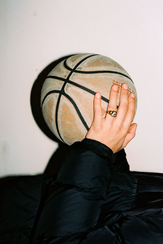 Hand wearing ring holding basketball