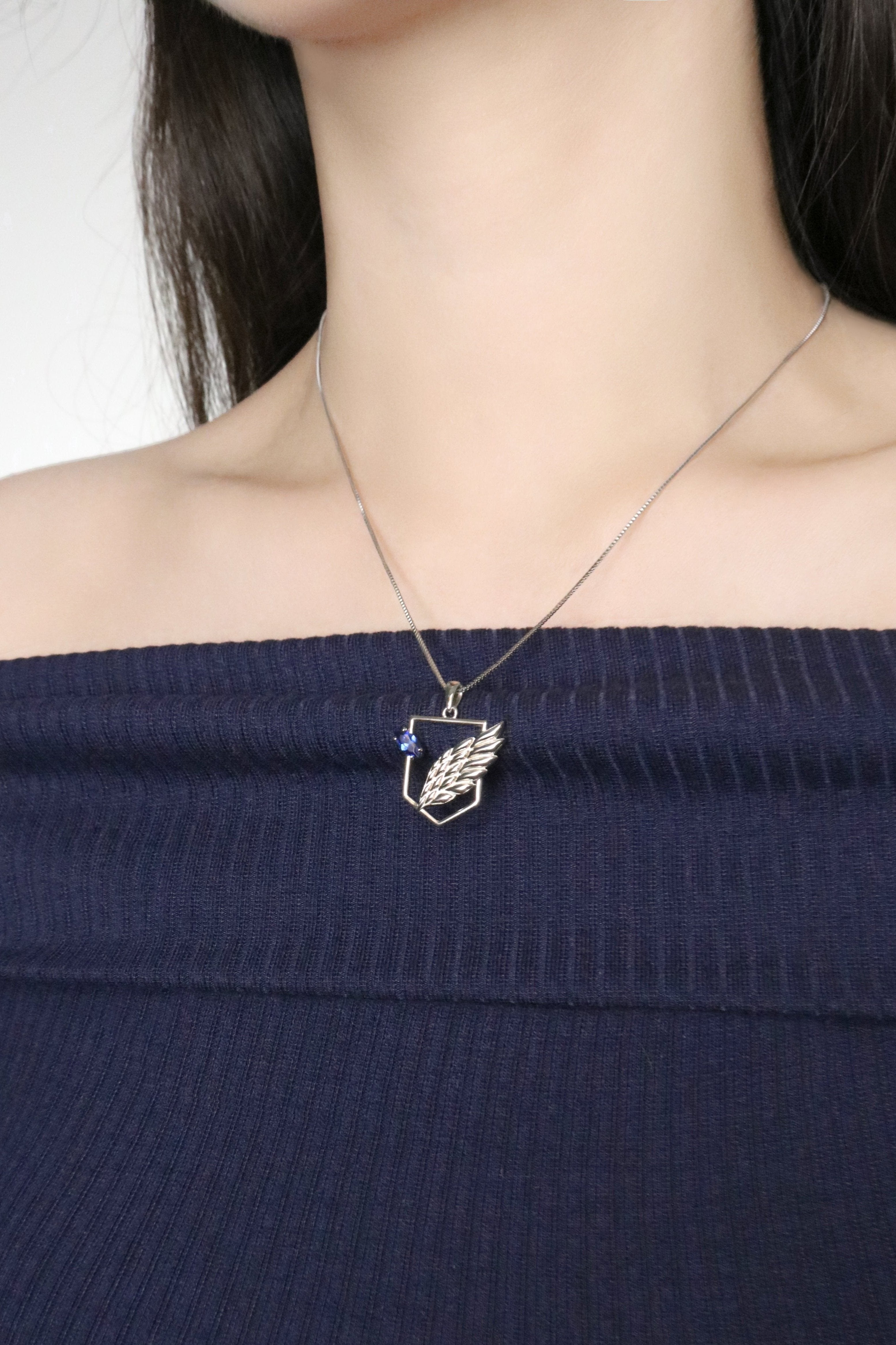 AOT Wings of freedom necklace around neck on model with hair down