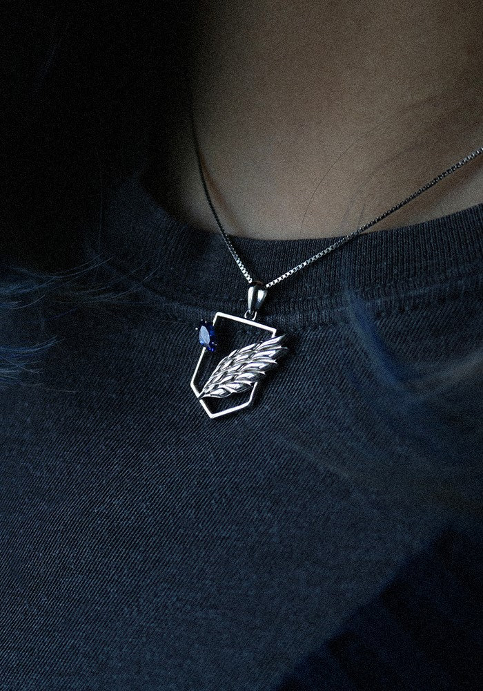 A model wearing the silver Scout Pendant, showing the subtle scale and sleek aesthetic of this freedom-inspired jewelry.