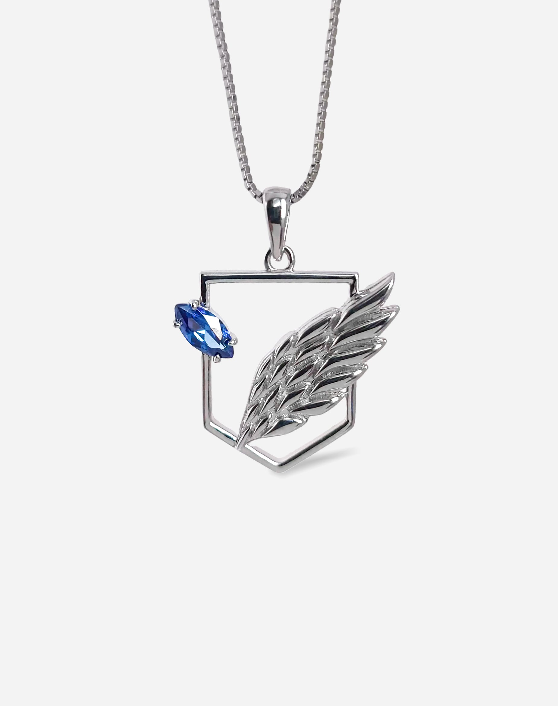 925 sterling silver Scout Pendant featuring a minimalist wing design and a blue sapphire zirconia crystal. By BOY OZU.