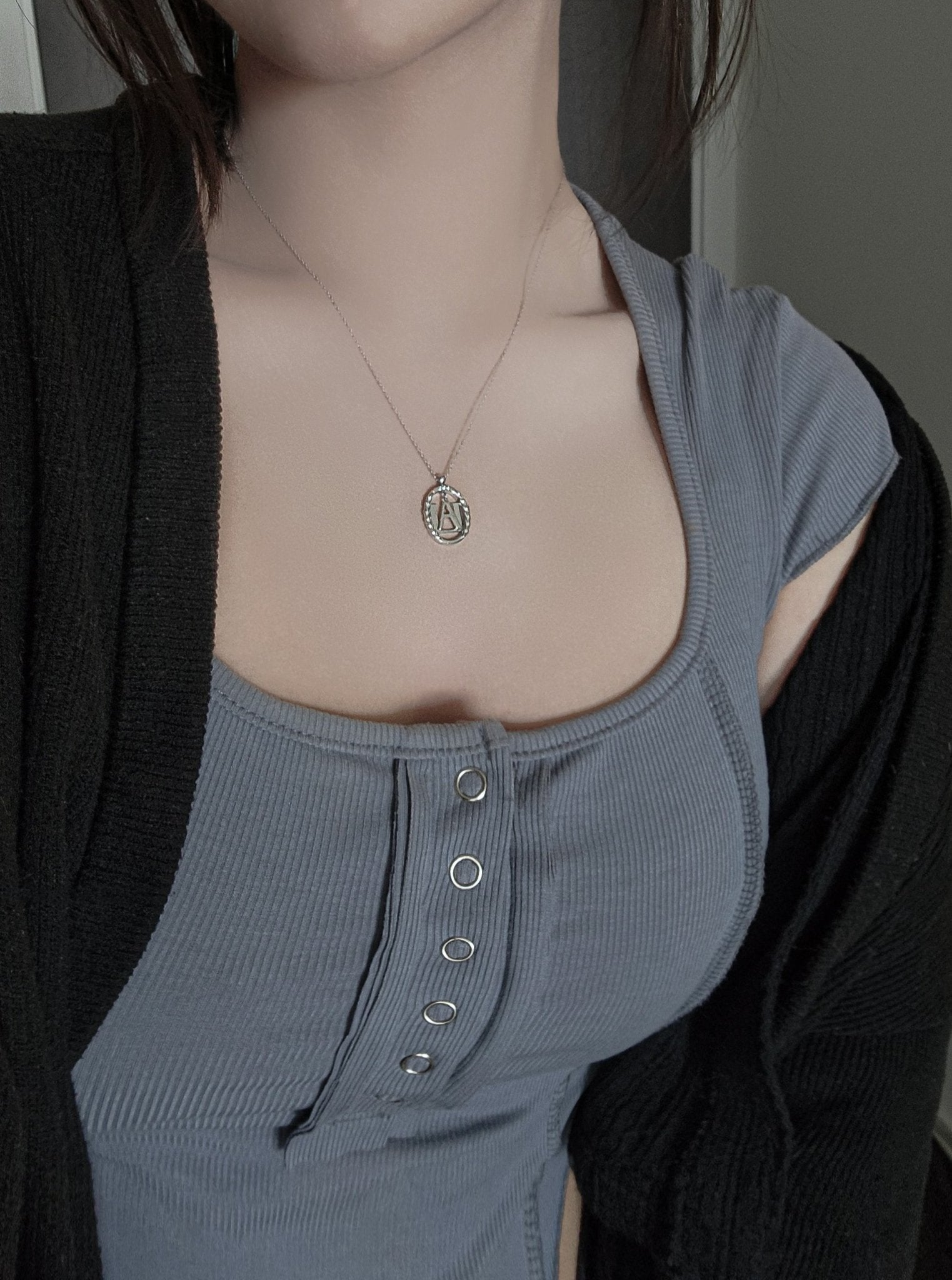 Model wearing silver U.A. High necklace, showing the scale and minimalist fit on a person.